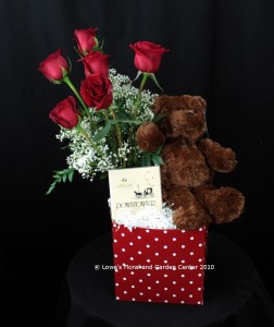 The My Everything Gift Box from Lowe's Floral contains a plush brown teddy bear, gourmet chocolates and a half dozen premium Ecuadorian roses.
